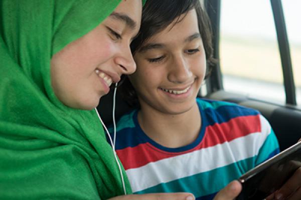 Brother and sister listening to music